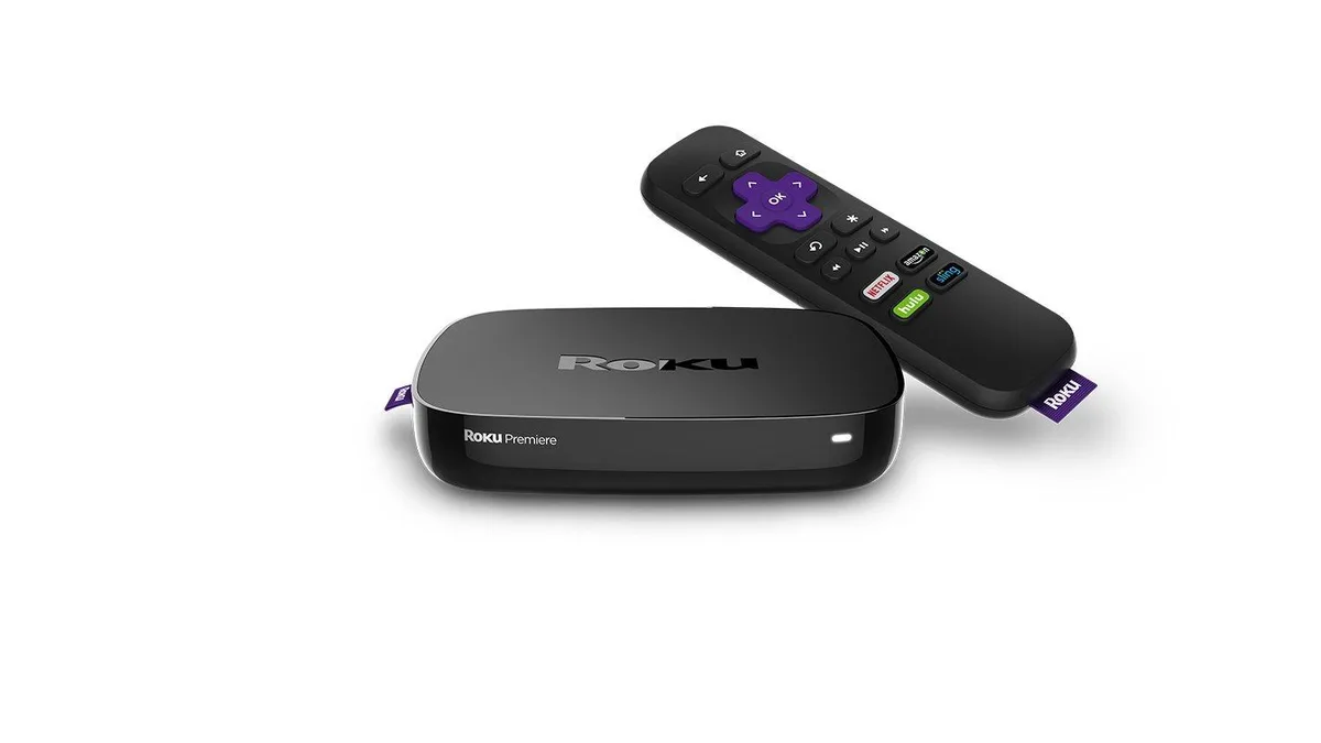 Small square black streaming box with HDMI and remote