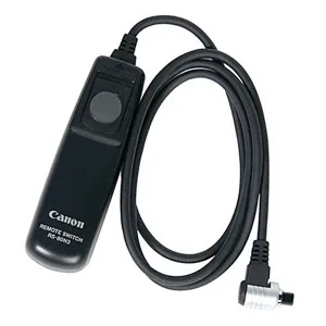 Black wired remote switch with coiled cable, compact rectangular body, Canon branding visible