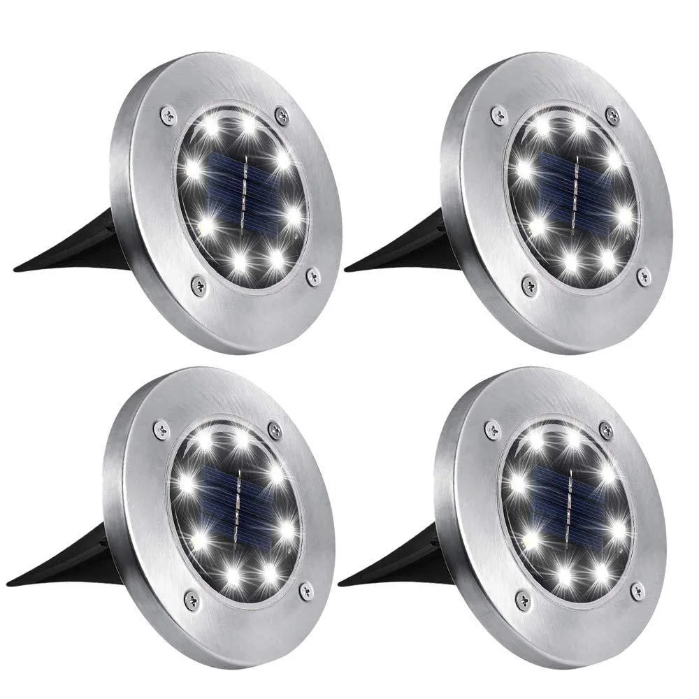 Four black resin ground lights with solar panels, spike bases and brackets