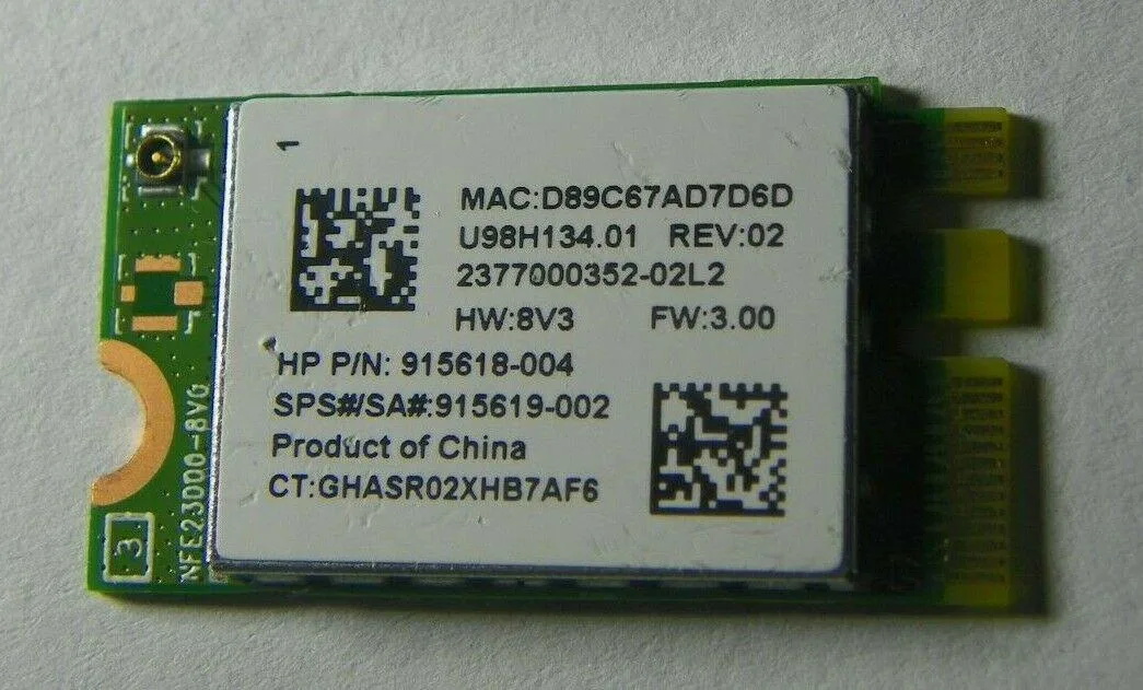 Small green circuit board with gold edge connector and two antenna sockets