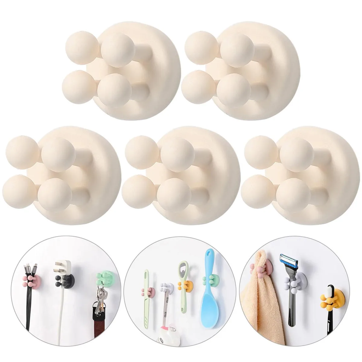 Five small white silicone adhesive hooks on a backing card