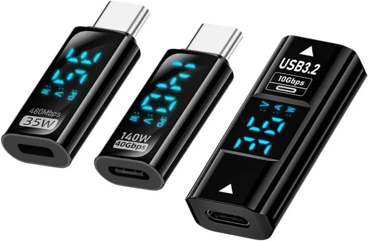 Three small USB-C adapters with digital displays, gold contacts, matte finish