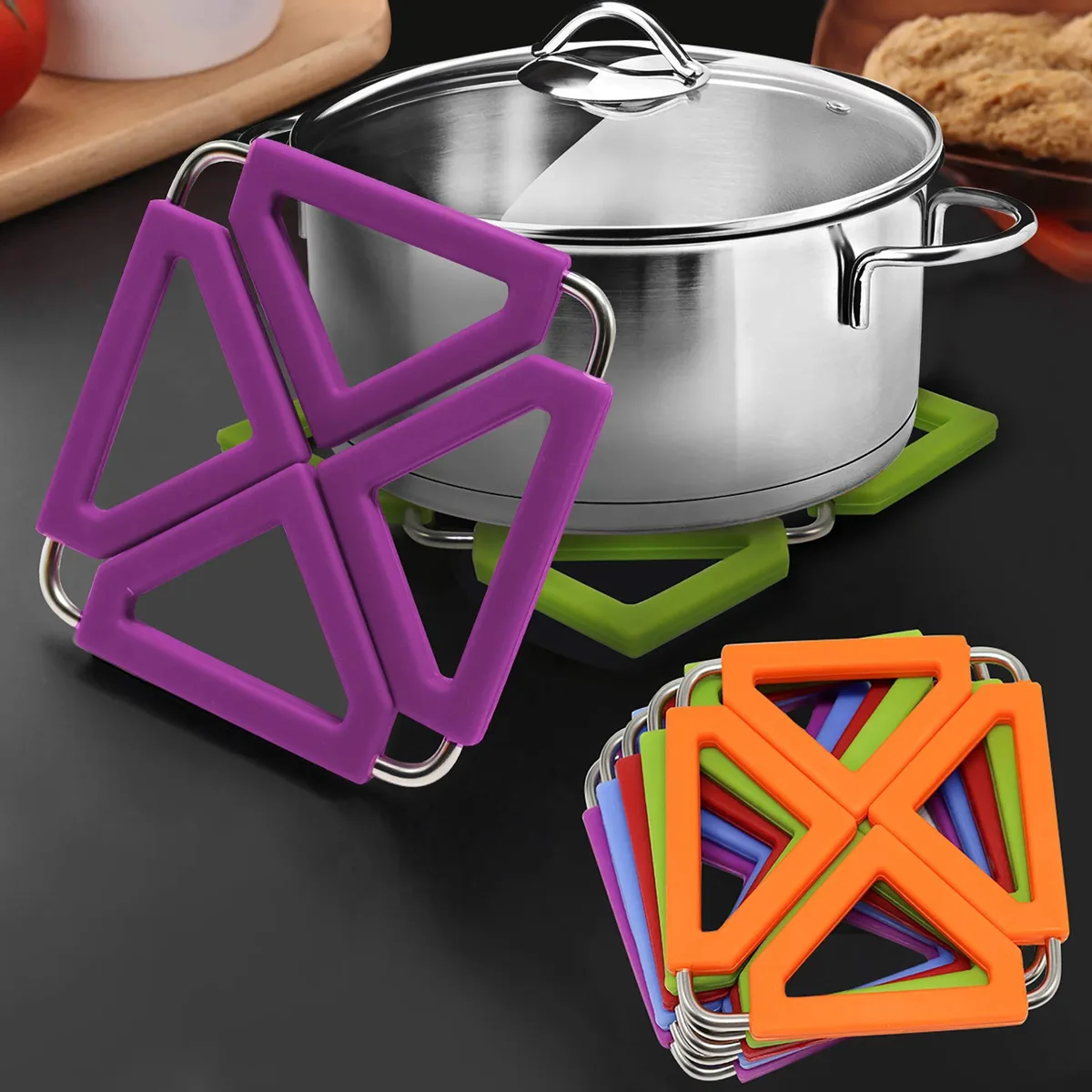 Five square silicone trivets with stainless steel frames in red purple orange green blue