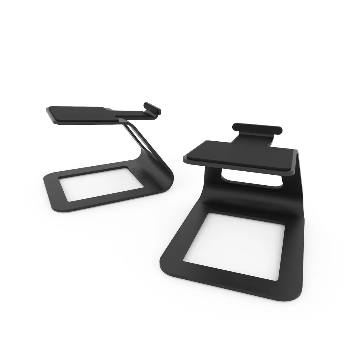 Pair of black metal desktop speaker stands with angled cantilevered platforms and silicone padding, compact rectangular profile
