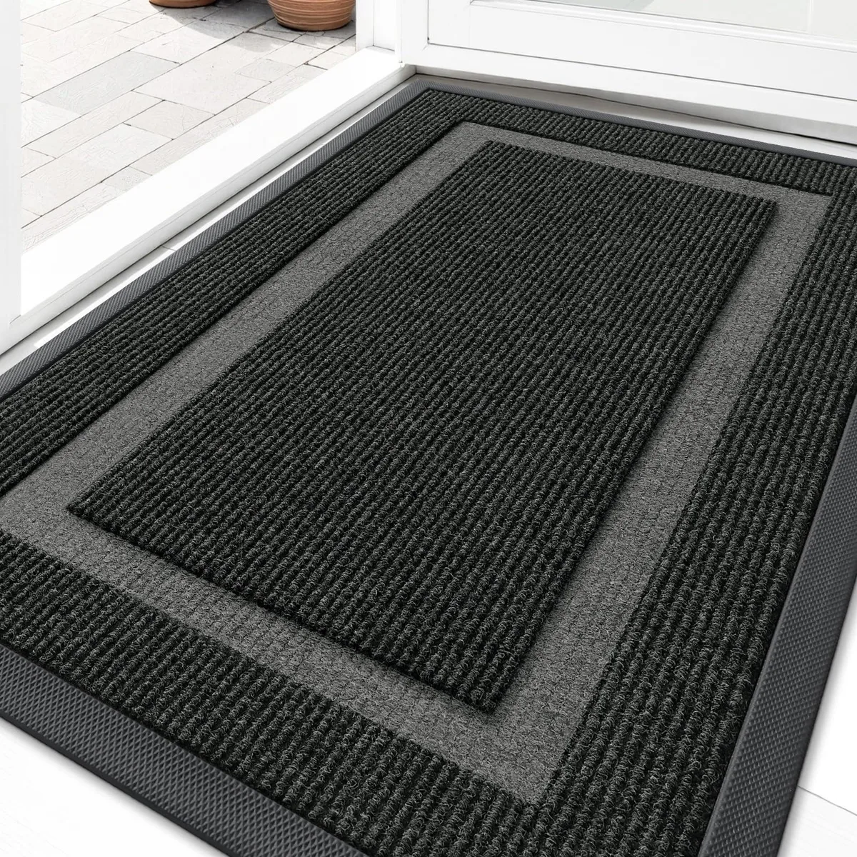 Black rectangular door mat with classic border pattern and low-profile natural rubber backing