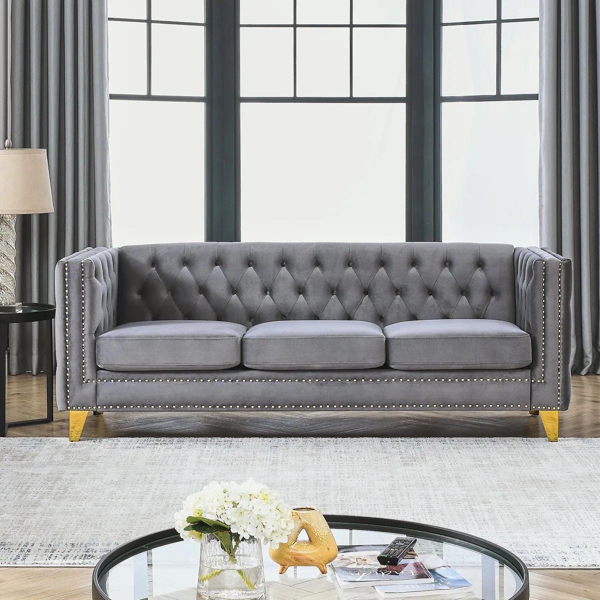 Grey velvet Chesterfield sofa with tufted buttons, nailhead trim, square arms and metal legs