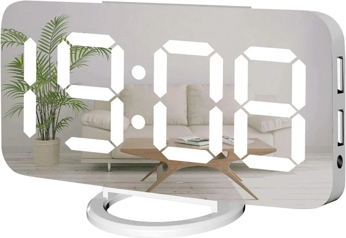 White rectangular digital alarm clock with mirrored display, three front buttons, top snooze bar, two USB ports on side