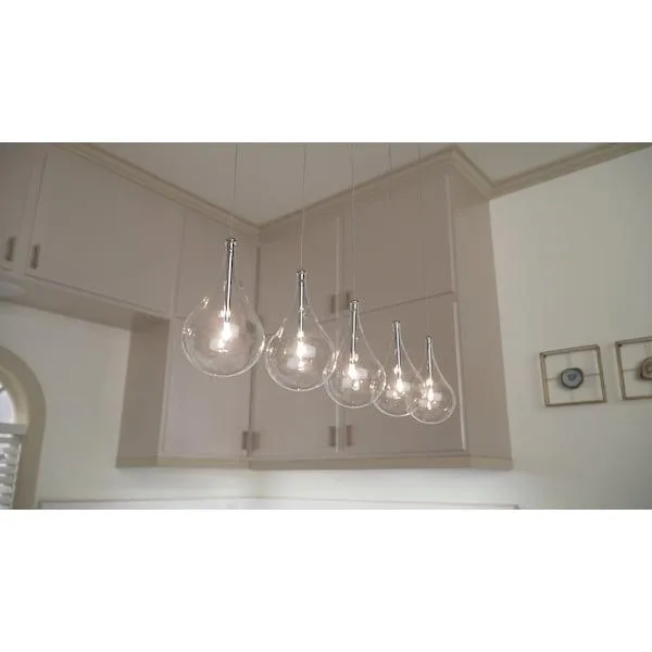 Polished chrome linear pendant with five clear teardrop glass drops on adjustable aircraft cables