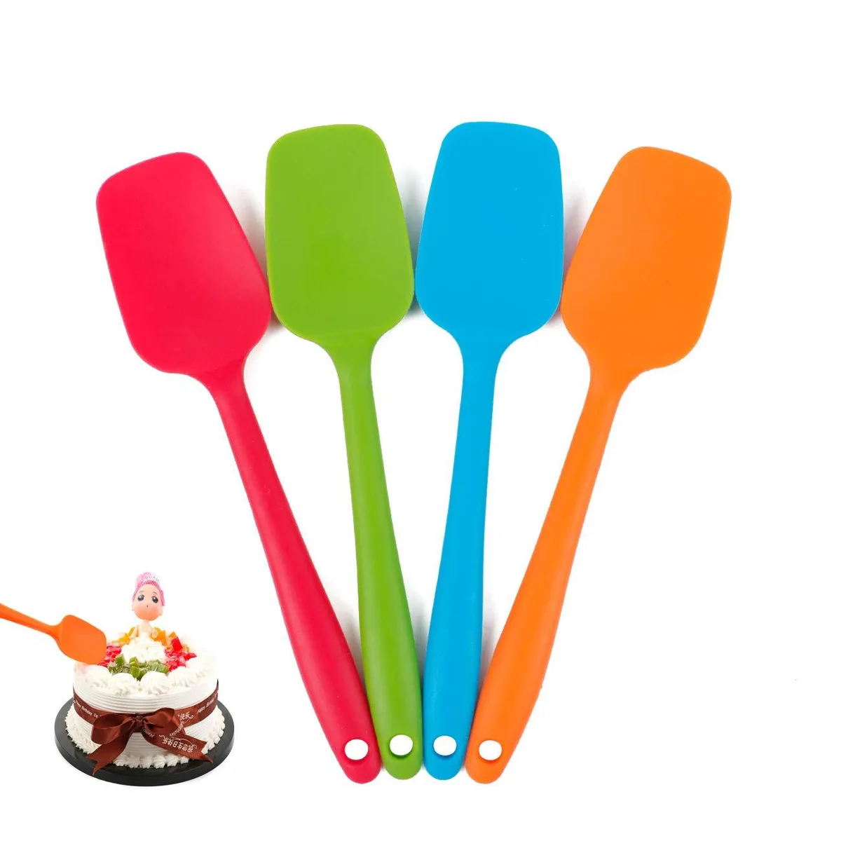 Four flexible silicone spatulas in blue, red, green, orange with curved heads and steel cores