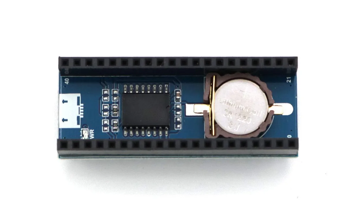 Small green circuit board with DS3231 chip, battery holder and female pin headers