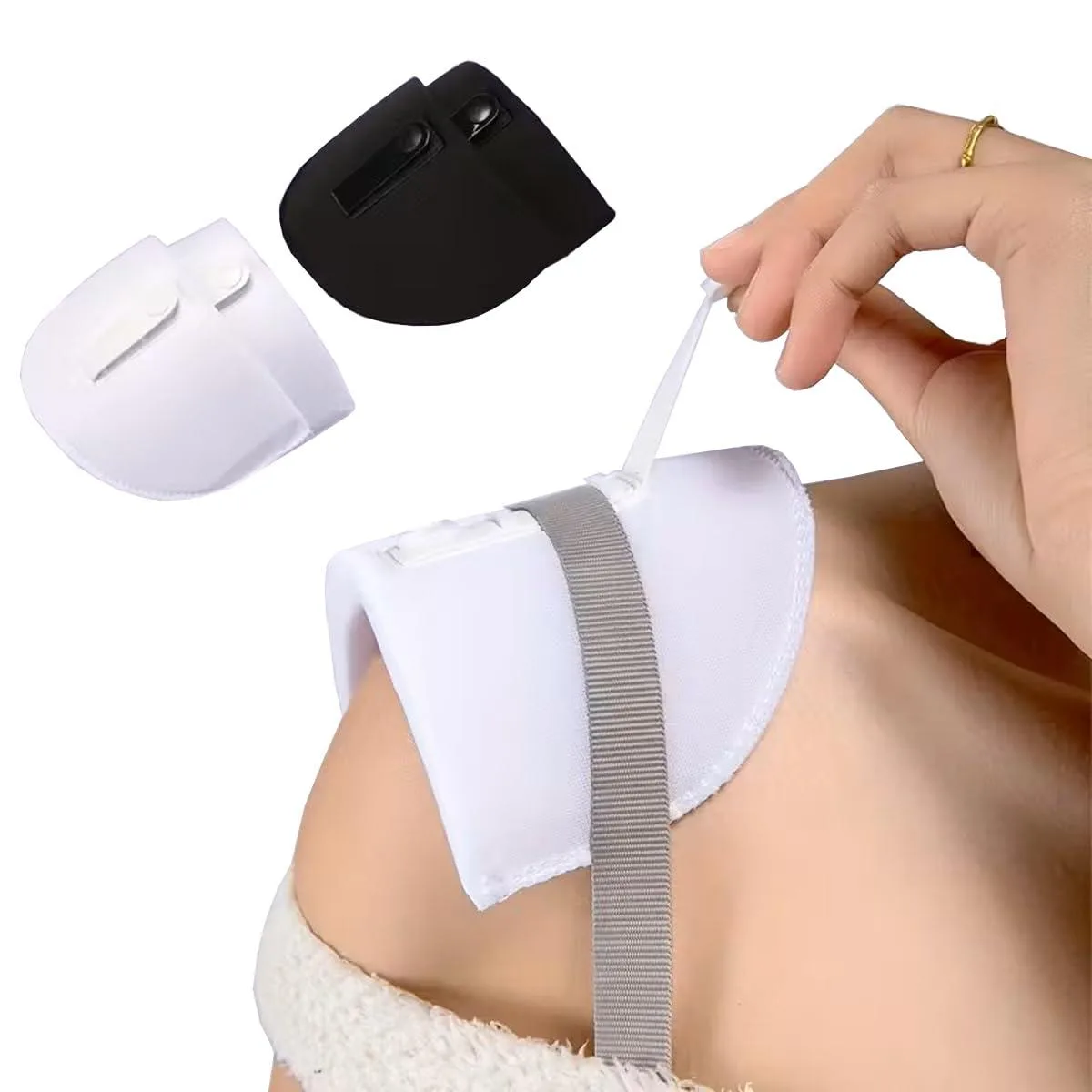 Two pairs of black and white foam shoulder pads with buckle fasteners