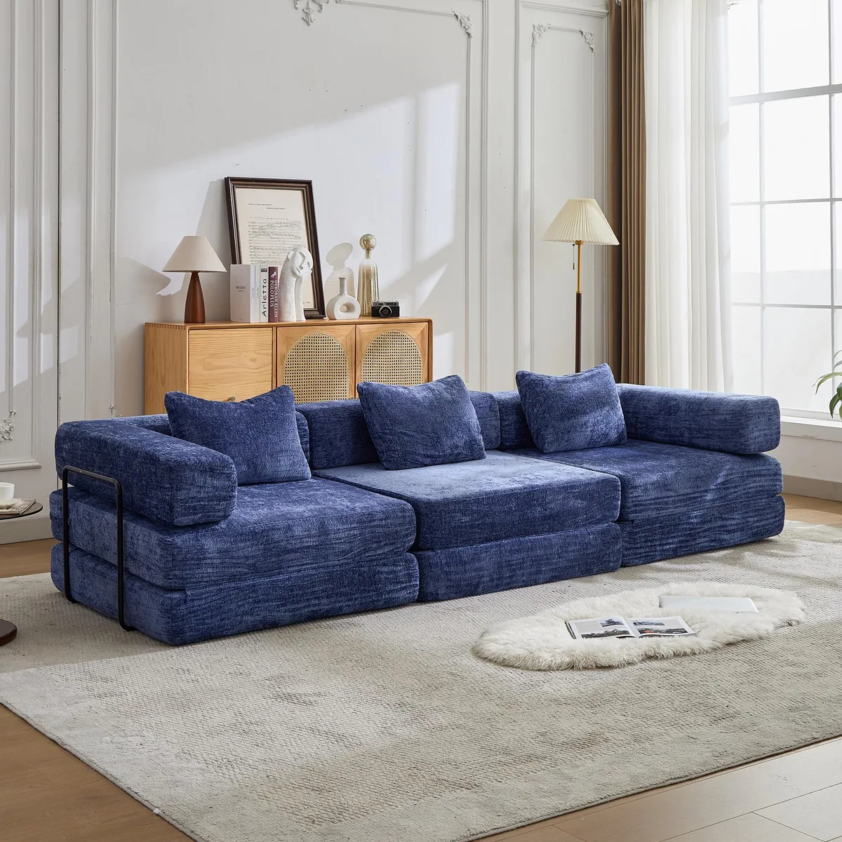 Dark blue chenille modular floor sofa bed, folded flat with side armrests visible