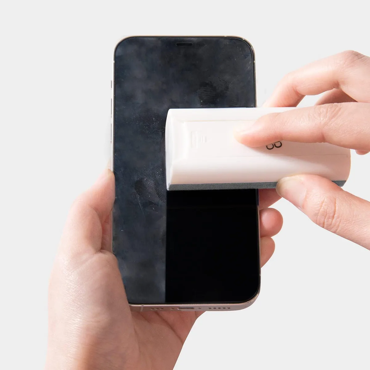 White spray bottle with grey microfiber cloth and fold-out phone stand