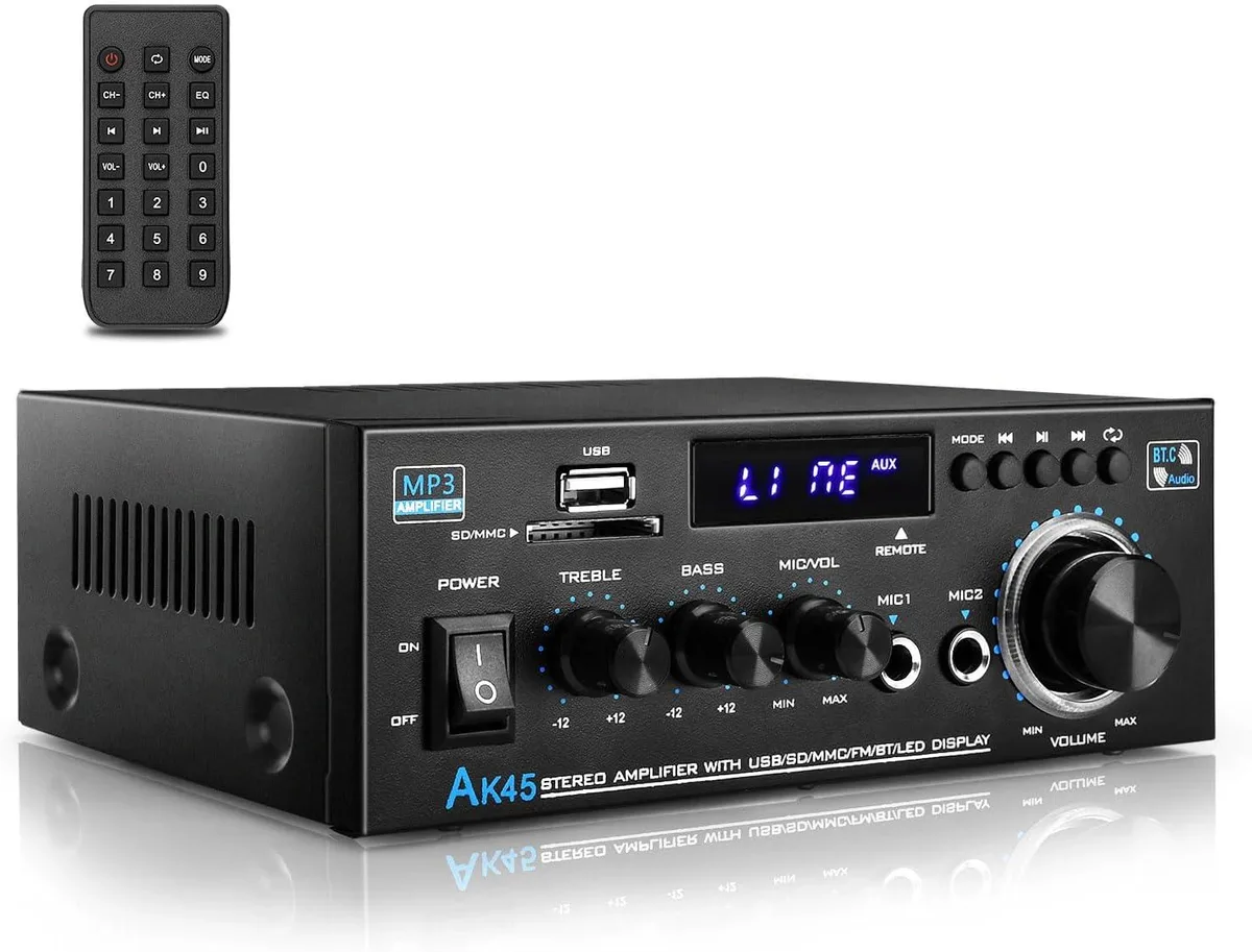 Compact black stereo amplifier with front panel knobs and multiple input ports