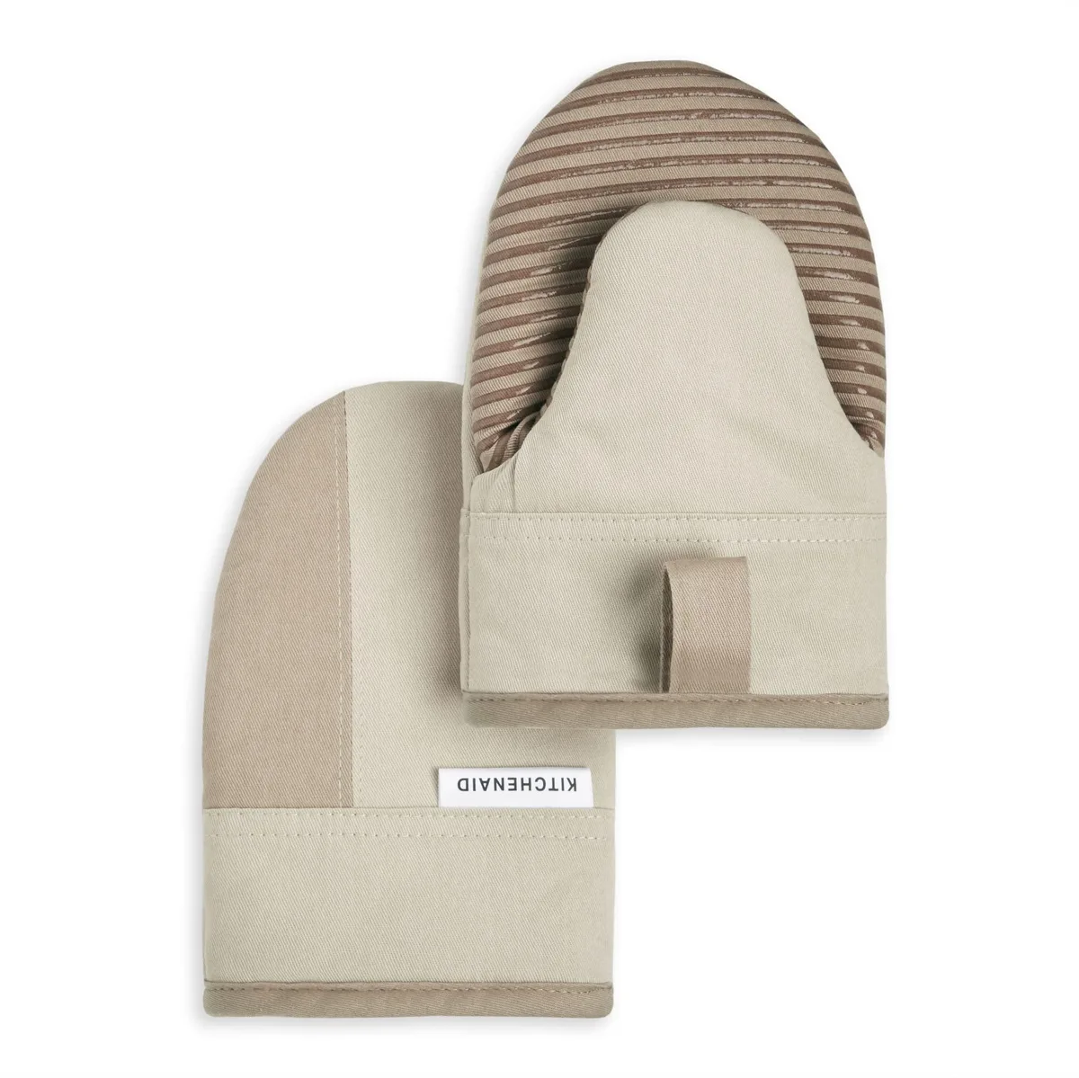 Two beige and tan mini oven mitts with silicone grip and hanging loops