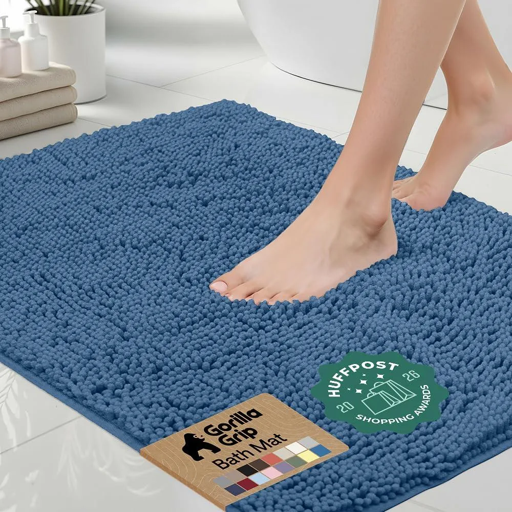 Blue rectangular bath rug with thick chenille pile and rubber backing, 24 by 17 inches