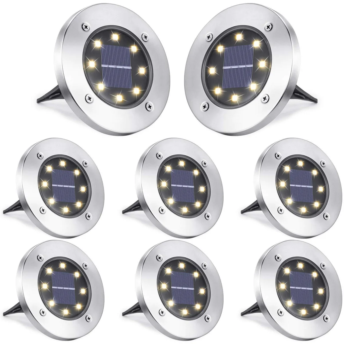 Eight stainless-steel solar disk lights with warm-white LEDs, flat round form, spike bases visible