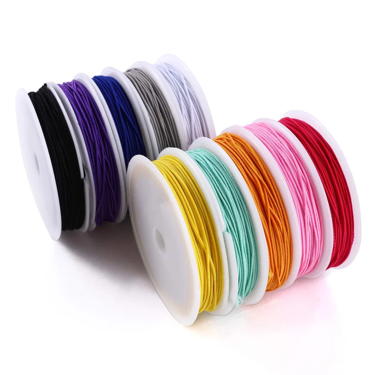 Ten multicolour elastic cord rolls on plastic spools