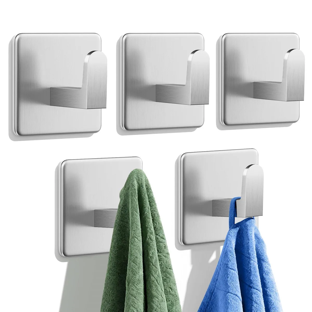 Five silver stainless steel adhesive hooks on a white background