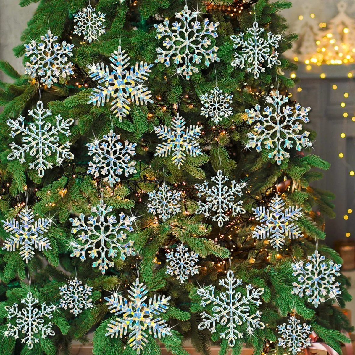 Thirty-six iridescent plastic snowflake ornaments in three sizes with silver hanging cords