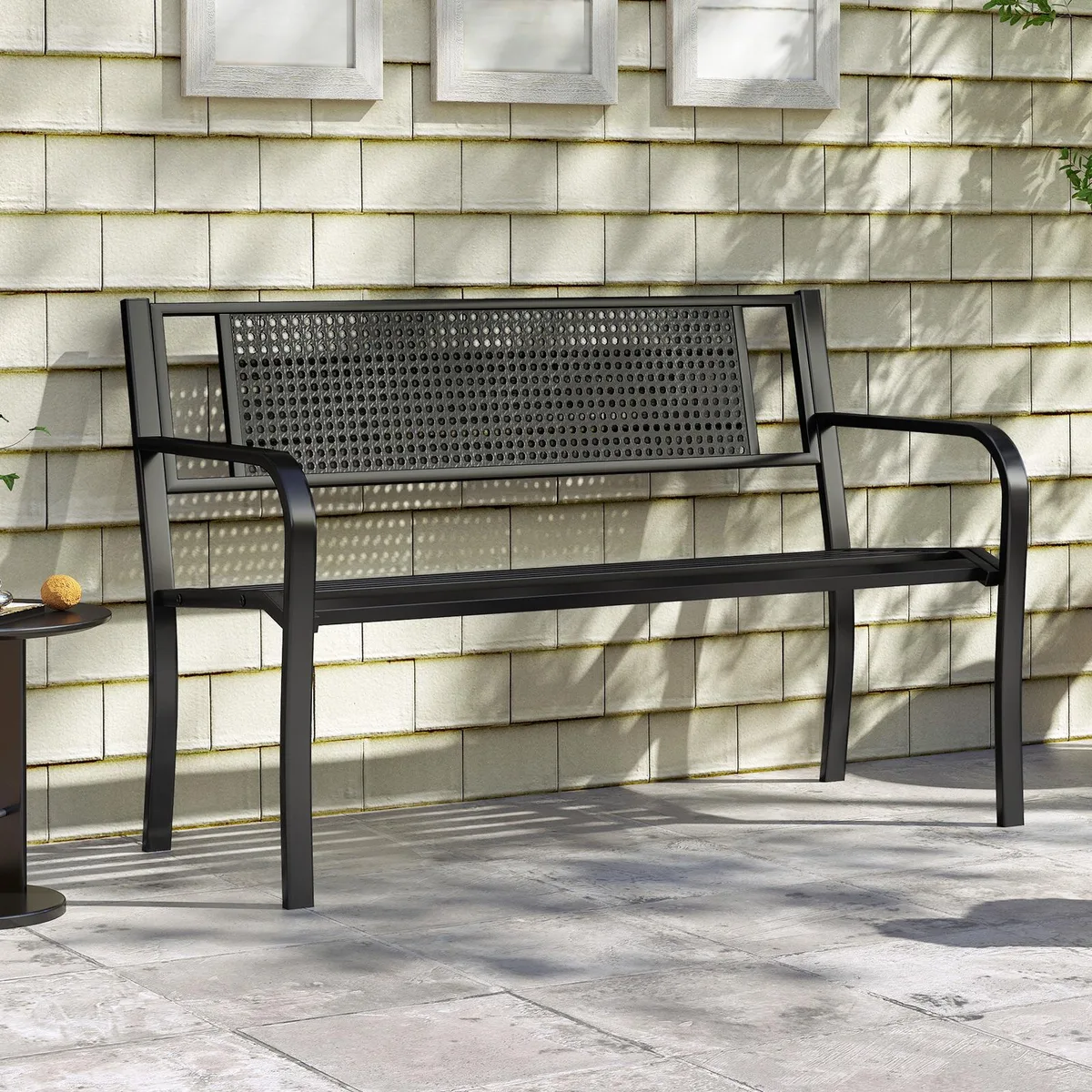 A 50-inch black and grey metal garden bench with patterned backrest and curved armrests