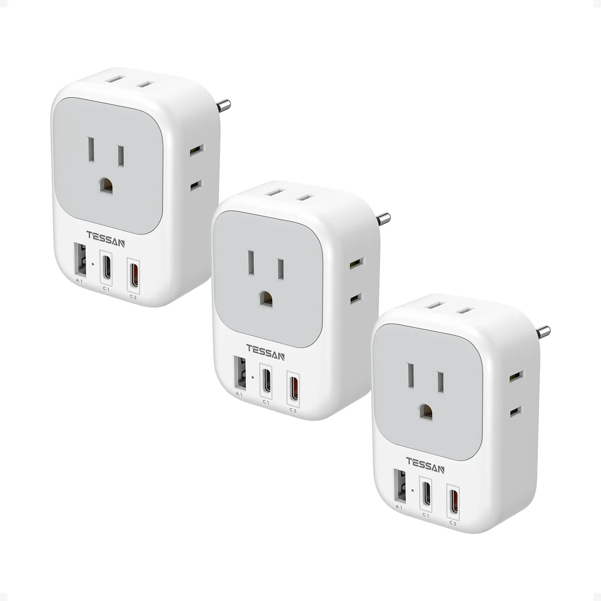 Three grey rectangular travel adapters with EU pins, four AC sockets, two USB-C ports and one USB-A port