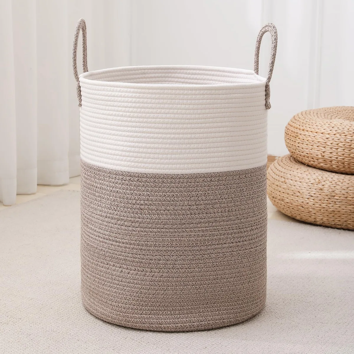 Tall woven rope laundry hamper in white and brown with cotton handles