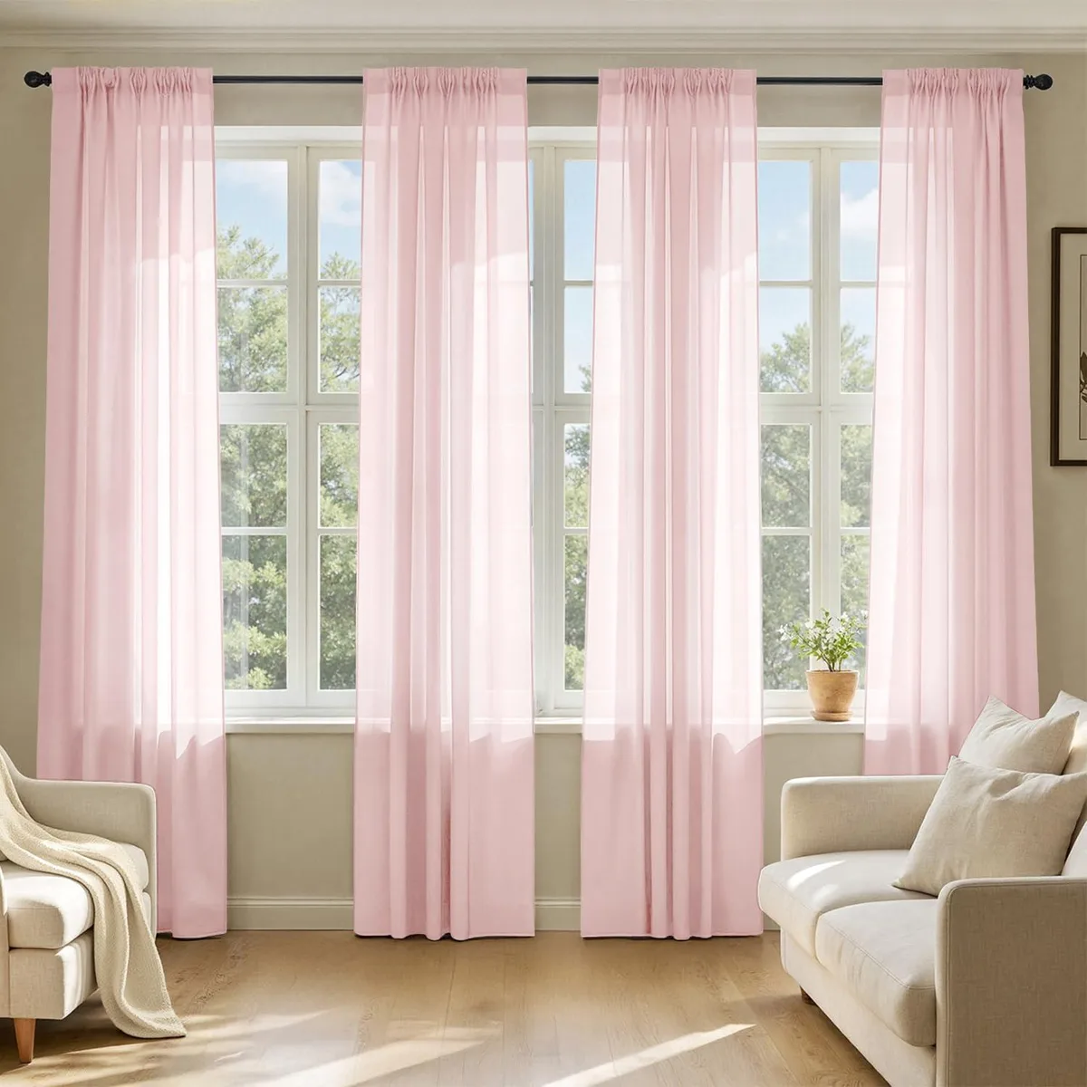 Four blush pink sheer polyester curtain panels with rod pockets