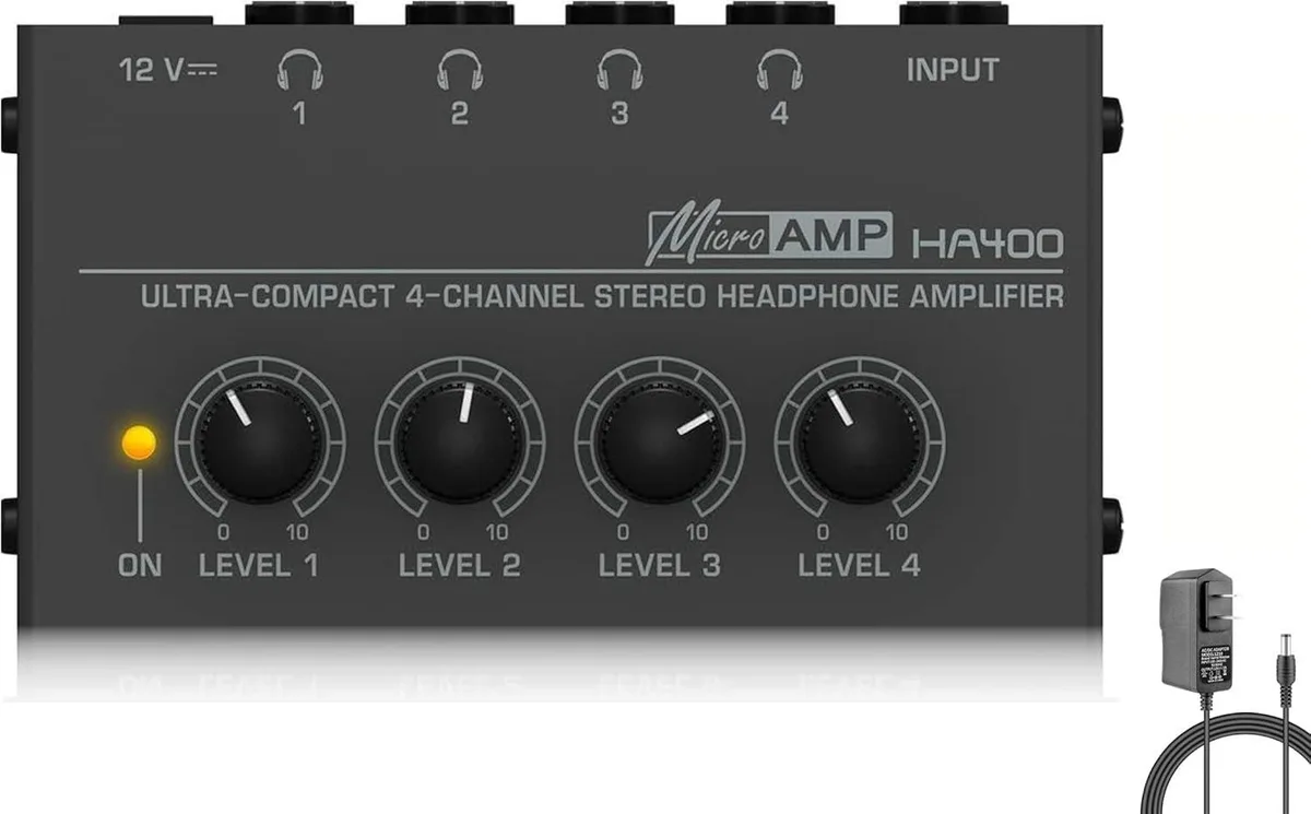 Compact metal box with four headphone jacks and volume knobs