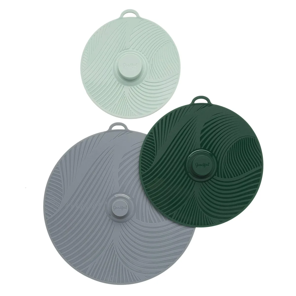 Three round silicone lids in grey, green and sage, stacked by size