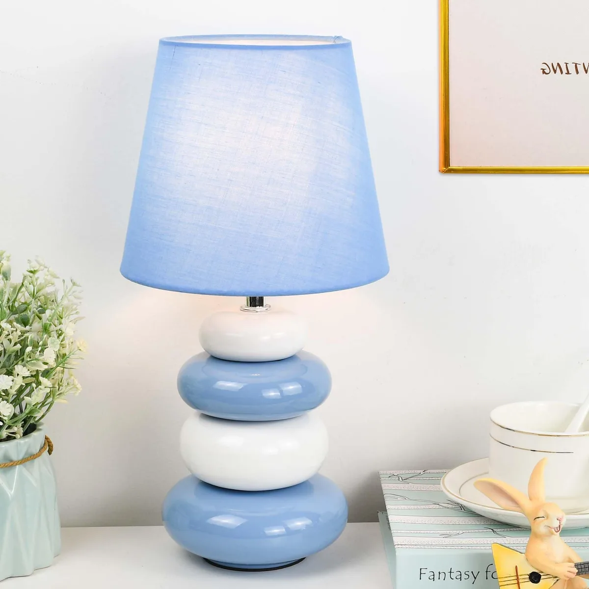 Light blue ceramic barrel base with matching fabric shade, 6.5 by 12.44 inches