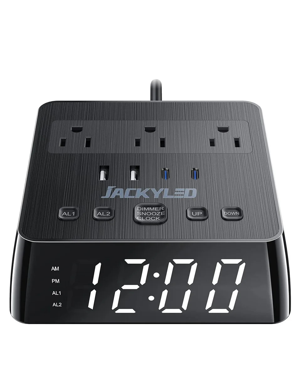 Black cube alarm clock with full-screen LED display, three AC outlets and four USB ports on top