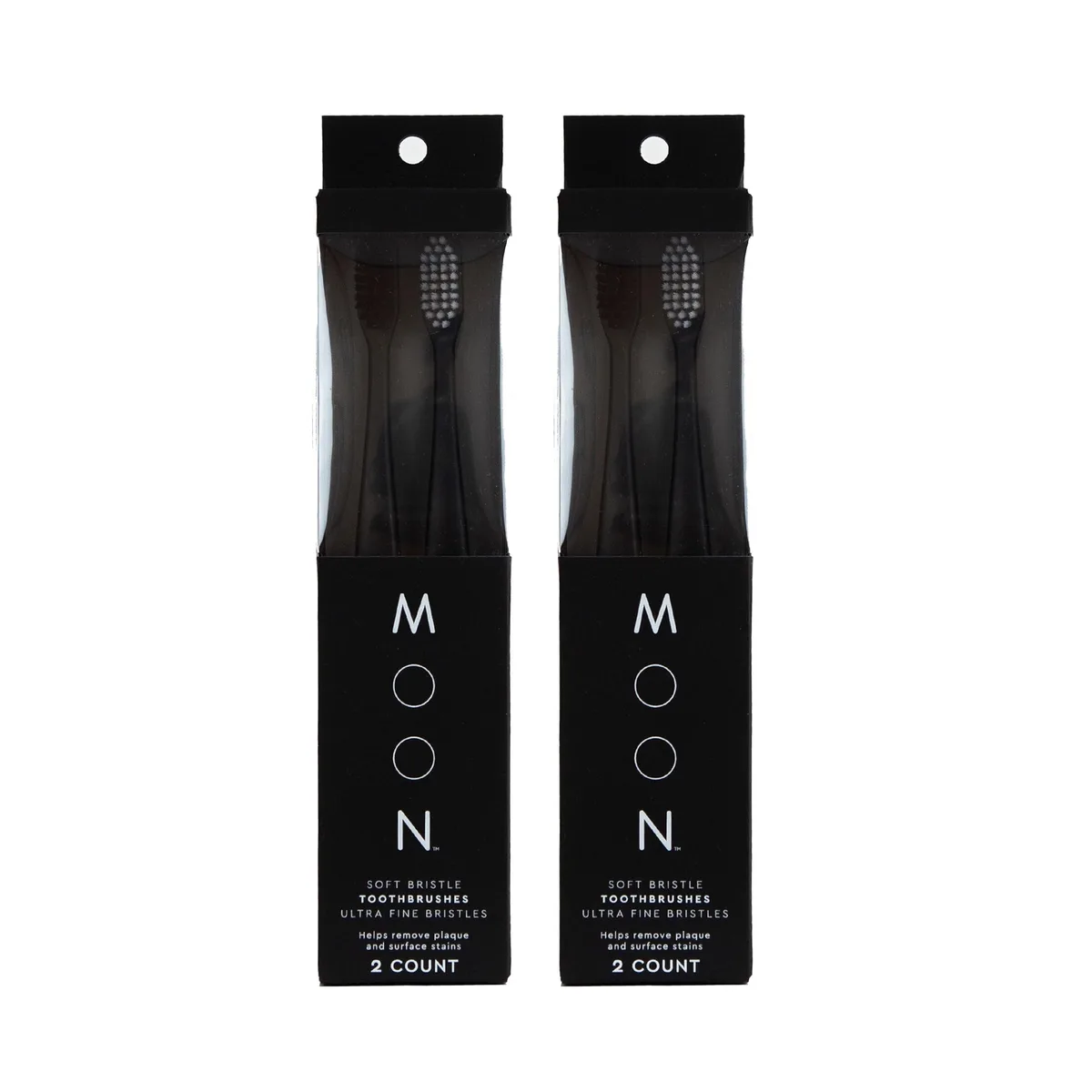 Four black manual toothbrushes with ultra-fine bristles in a rectangular pack