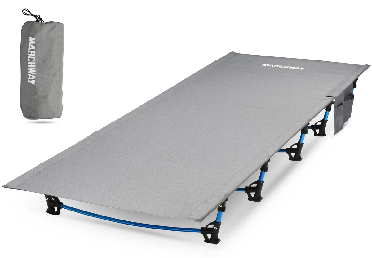 Grey folding cot with aluminium frame and ripstop nylon fabric packed in a compact stuff sack