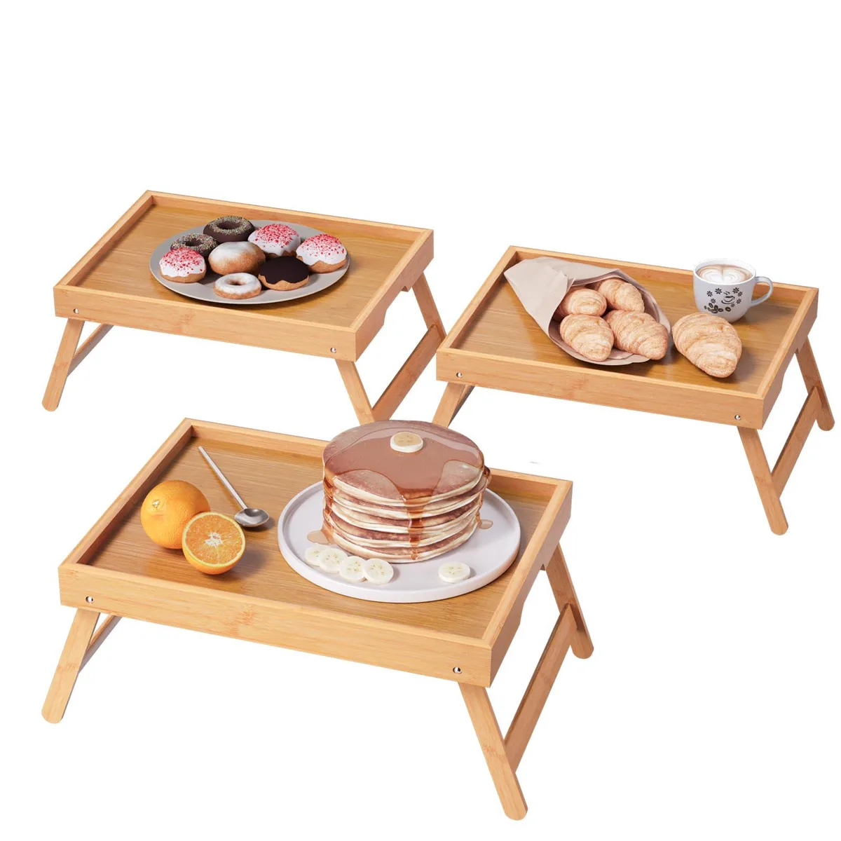 Three natural bamboo bed trays with folded legs and raised edges, flat rectangular tops, light wood grain finish