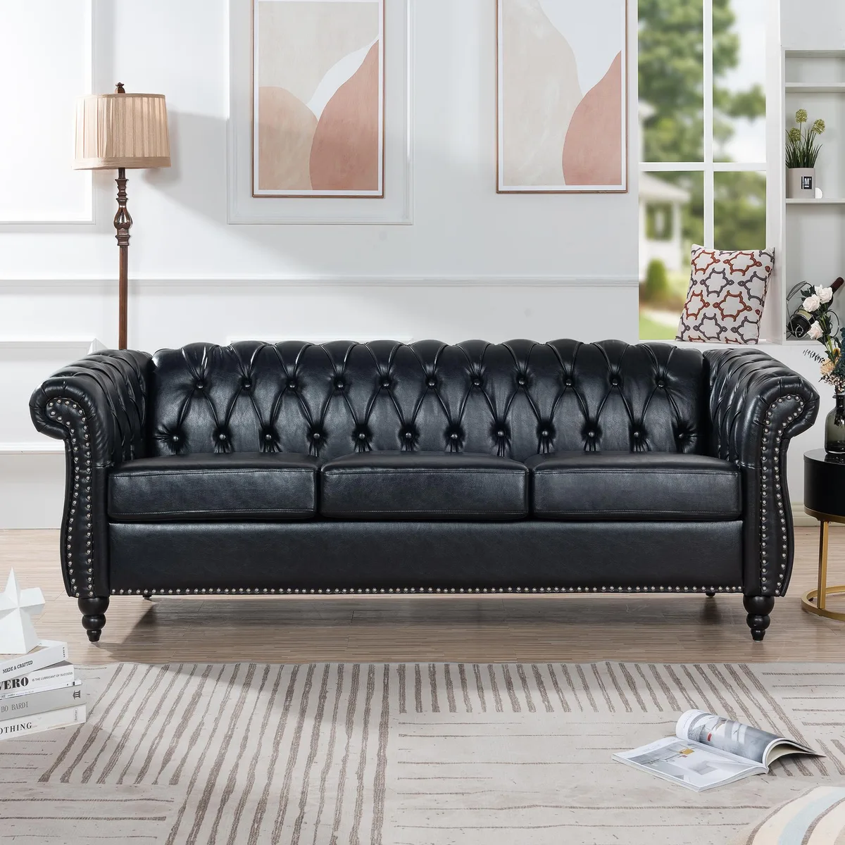 Black PU Chesterfield three-seater sofa with rolled arms and deep button tufting
