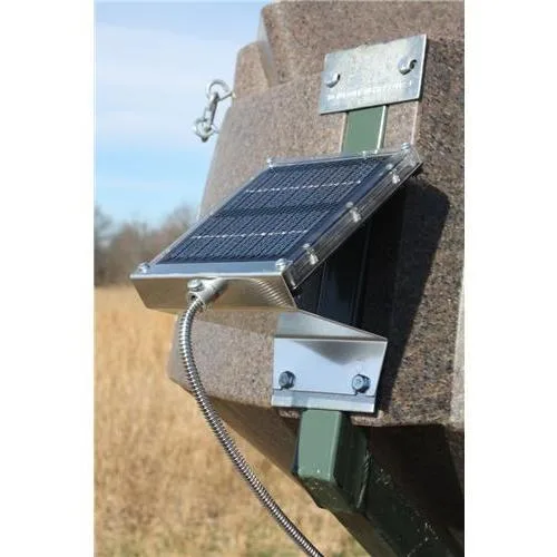 Small black rectangular solar panel with wire guard and conduit covering, drum mount hardware included
