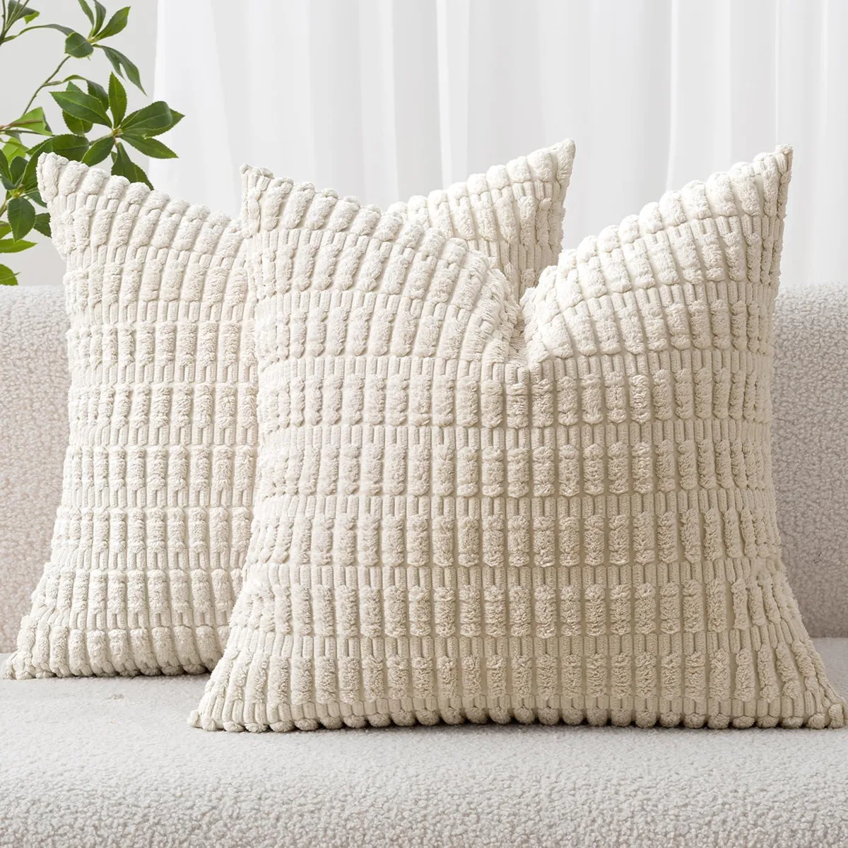 Two square cream corduroy pillow covers with striped texture