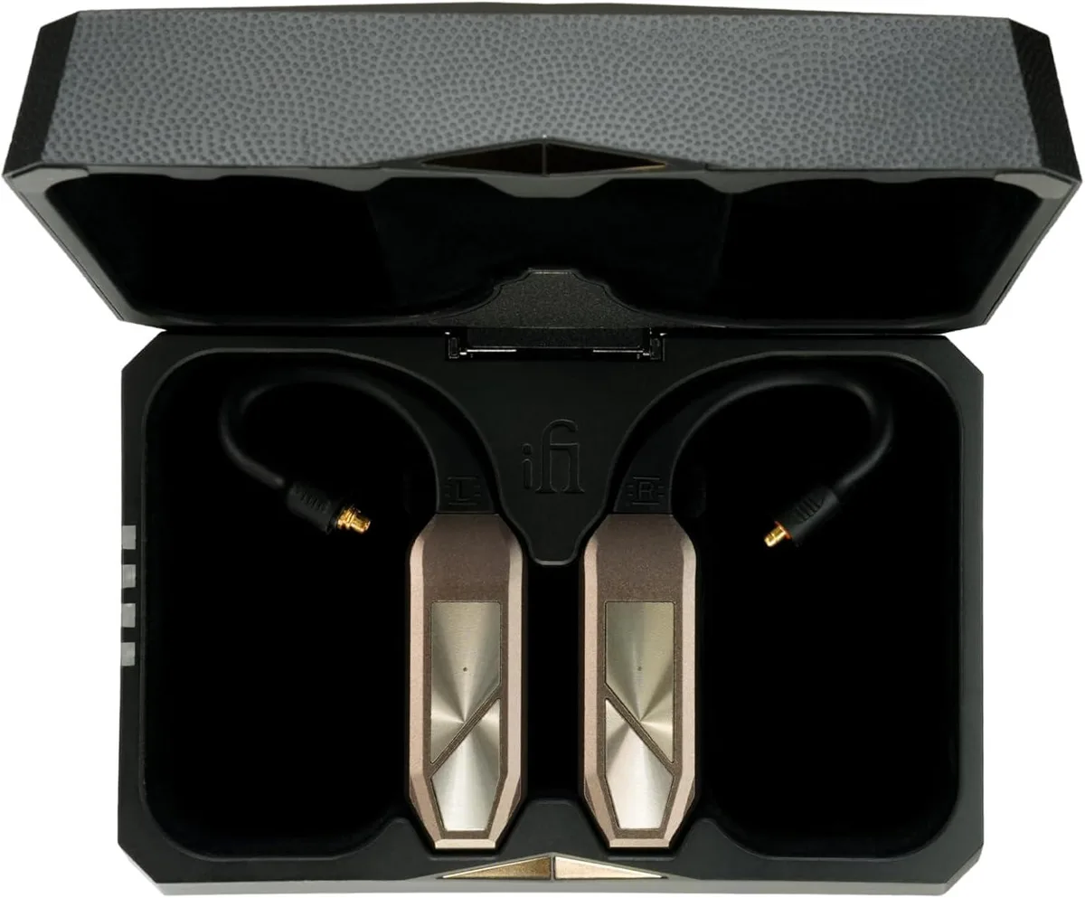 Two compact wireless earbud pods in a matte finish charging case with ear loops attached