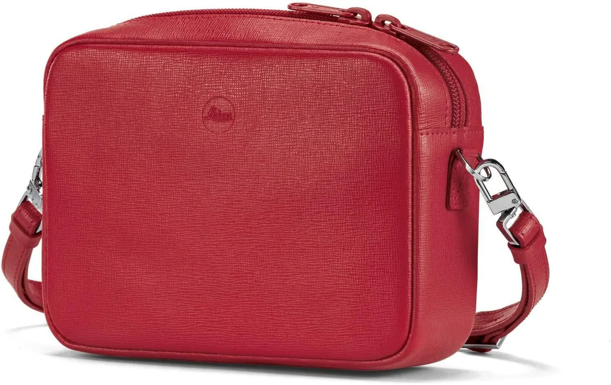 Red leather handbag with dual zippers, detachable strap, open camera pocket and extra pocket