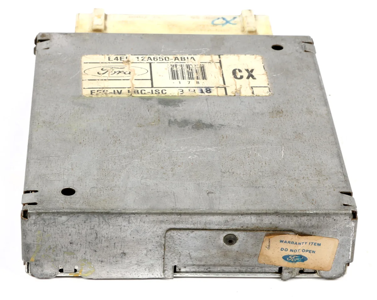 Rectangular automotive control module, dark plastic housing with multiple connector ports, new old stock condition