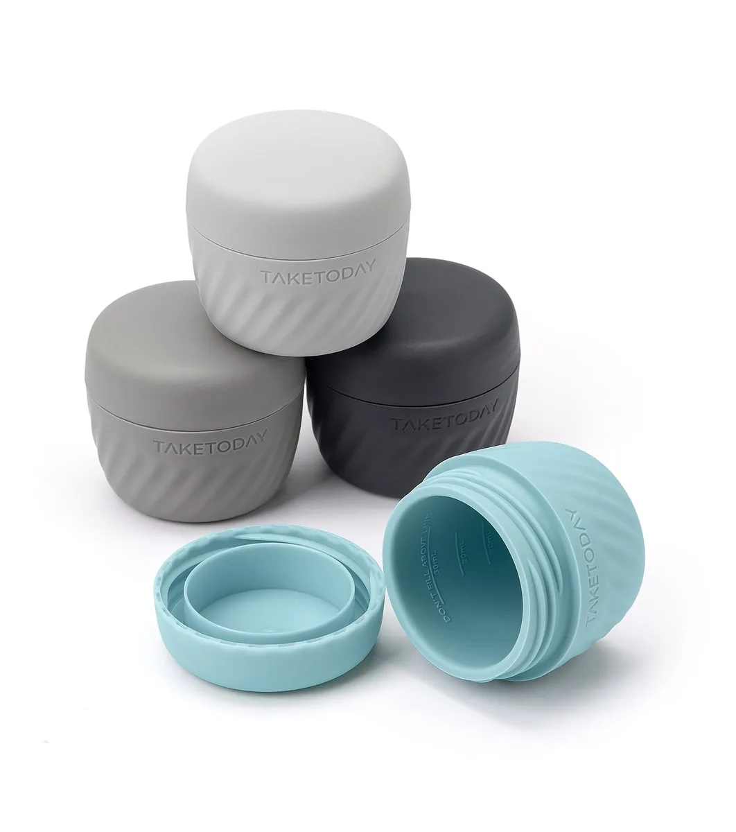 Four grey silicone travel jars with wide white lids
