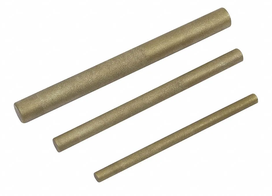 Three brass drift punches on a light background