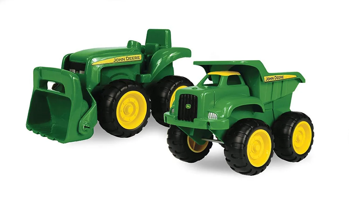 Two small green and yellow construction vehicles, a dump truck and a tractor with loader