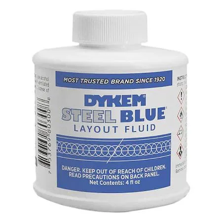 Blue layout fluid in a small brush-cap bottle