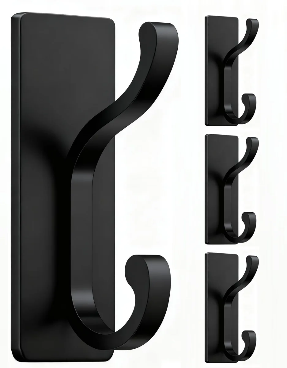 Four black adhesive wall hooks with smooth finish