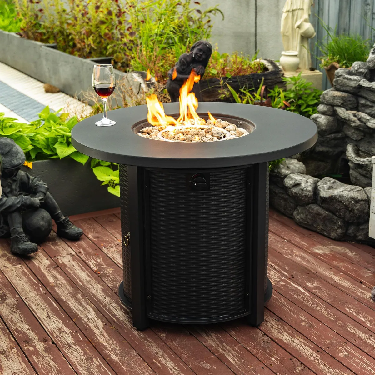 Round black steel fire pit table with integrated propane tank storage