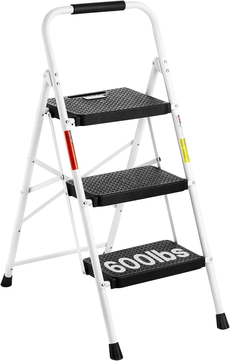 White three-step folding steel ladder with wide anti-slip pedals and handgrip, shown open