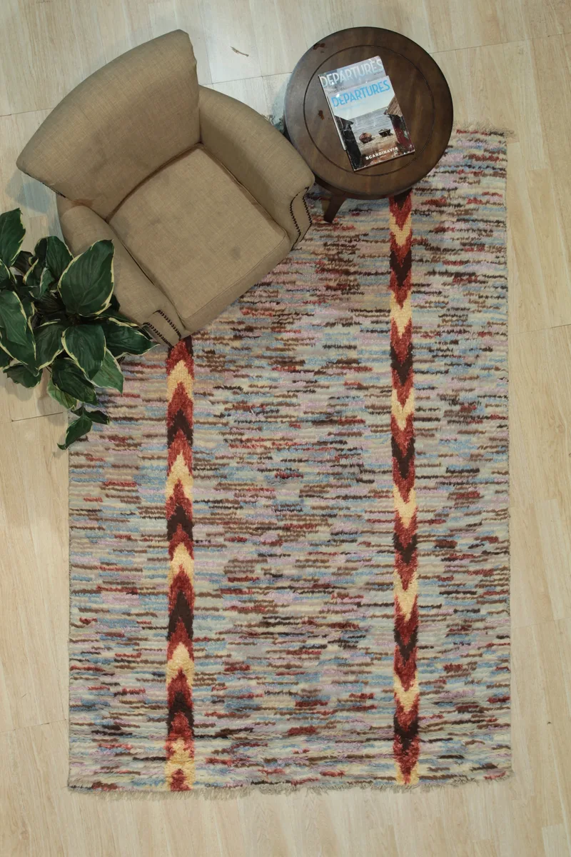 Hand-knotted wool and silk rug with geometric pattern in multiple colours