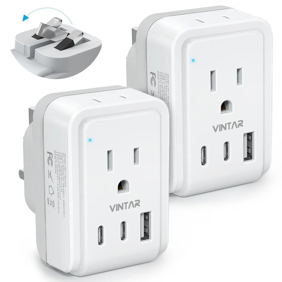 Two white and grey Type G travel adapters with foldable plugs, each showing two AC outlets, two USB-C ports and one USB-A port